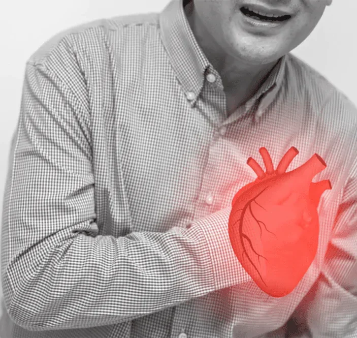 A man clutching his chest in pain, with a red highlighted heart illustration indicating possible heart issues.